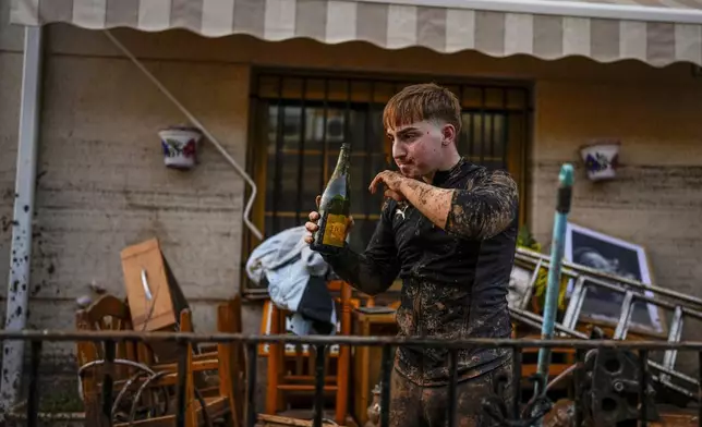 A man reacts in front his house affected by floods in Utiel, Spain, Wednesday, Oct. 30, 2024. (AP Photo/Manu Fernandez)