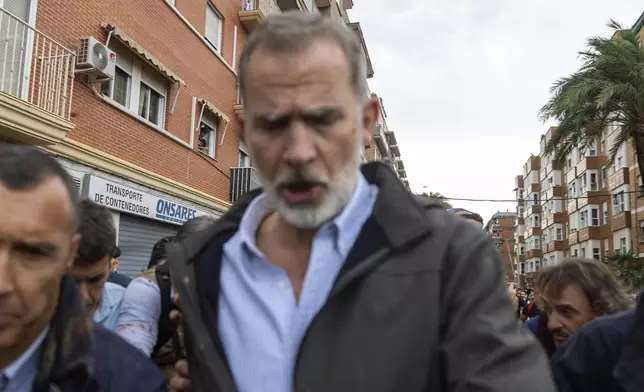 Spain's King Felipe VI walks amidst angry Spanish flood survivors in Paiporta, near Valencia, Spain, Sunday Nov. 3, 2024. (AP Photo/David Melero)