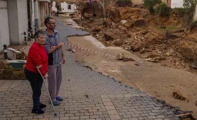 People look at an area affected by floods in Chiva, Spain, Friday, Nov. 1, 2024. (AP Photo/Manu Fernandez)