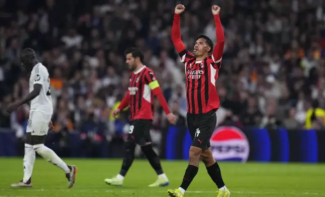 AC Milan's Tijjani Reijnders, right, celebrates after scoring his side's 3rd goal against Real Madrid during the Champions League opening phase soccer match at the Santiago Bernabeu stadium in Madrid, Spain, Tuesday, Nov. 5, 2024. (AP Photo/Manu Fernandez)