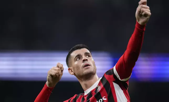 AC Milan's Alvaro Morata celebrates after scoring his side's 2nd goal against Real Madrid during the Champions League opening phase soccer match at the Santiago Bernabeu stadium in Madrid, Spain, Tuesday, Nov. 5, 2024. (AP Photo/Manu Fernandez)