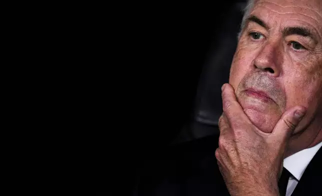 Real Madrid's head coach Carlo Ancelotti sits at the bench prior to the Champions League opening phase soccer match between Real Madrid and Borussia Dortmund at the Santiago Bernabeu stadium in Madrid, Tuesday, Oct. 22, 2024. Real Madrid won 5-2. (AP Photo/Manu Fernandez)