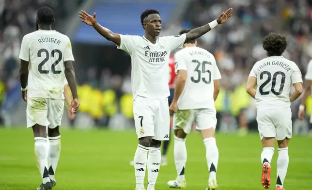 Real Madrid's Vinicius Junior celebrates after scoring his side's fourth goal during the Spanish La Liga soccer match between Real Madrid and Osasuna at the Santiago Bernabeu stadium in Madrid, Spain, Saturday, Nov. 9, 2024. (AP Photo/Jose Breton)