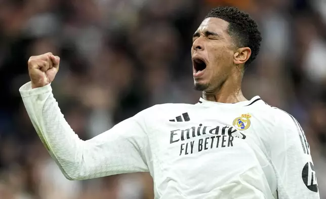 Real Madrid's Jude Bellingham celebrates after scoring his side's second goal during the Spanish La Liga soccer match between Real Madrid and Osasuna at the Santiago Bernabeu stadium in Madrid, Spain, Saturday, Nov. 9, 2024. (AP Photo/Jose Breton)