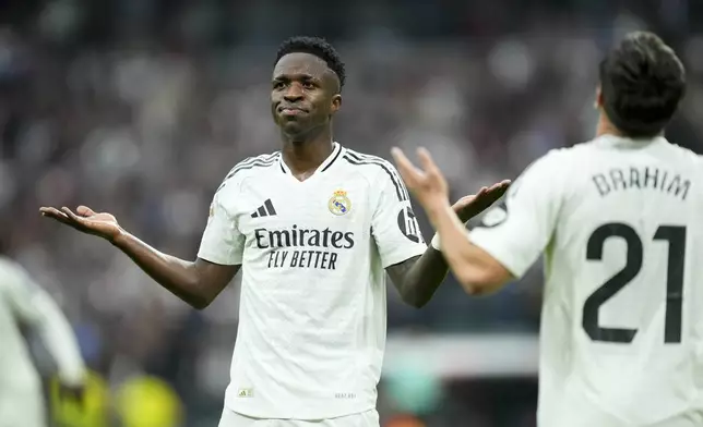 Real Madrid's Vinicius Junior celebrates after scoring his side's fourth goal during the Spanish La Liga soccer match between Real Madrid and Osasuna at the Santiago Bernabeu stadium in Madrid, Spain, Saturday, Nov. 9, 2024. (AP Photo/Jose Breton)