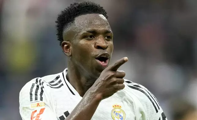 Real Madrid's Vinicius Junior celebrates after scoring his side's fourth goal during the Spanish La Liga soccer match between Real Madrid and Osasuna at the Santiago Bernabeu stadium in Madrid, Spain, Saturday, Nov. 9, 2024. (AP Photo/Jose Breton)