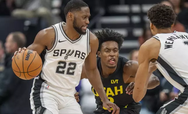 San Antonio Spurs guard Malaki Branham (22) is guarded by Utah Jazz guard Collin Sexton (2), during the first half of an NBA basketball game, Thursday, Oct. 31, 2024, in Salt Lake City. (AP Photo/Rick Egan)