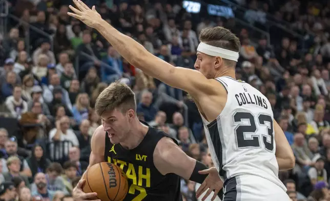 Utah Jazz forward Kyle Filipowski (22) breaks for the basket as San Antonio Spurs forward Zach Collins (23) defends during the first half of an NBA basketball game, Thursday, Oct. 31, 2024, in Salt Lake City. (AP Photo/Rick Egan)