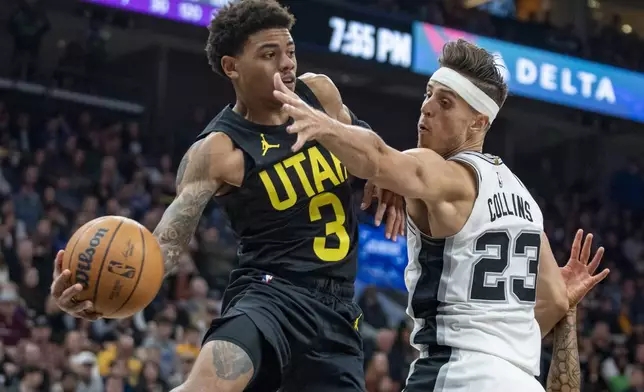 Utah Jazz guard Keyonte George (3) passes the ball outside as San Antonio Spurs forward Zach Collins (23) defends, during the first half of an NBA basketball game, Thursday, Oct. 31, 2024, in Salt Lake City. (AP Photo/Rick Egan)