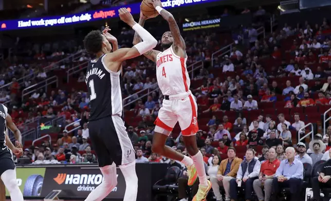 Houston Rockets guard Jalen Green (4) shoots over San Antonio Spurs center Victor Wembanyama (1) during the first half of an NBA basketball game Wednesday, Nov. 6, 2024, in Houston. (AP Photo/Michael Wyke)