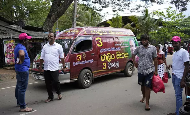 A van pasted with propaganda of Sri Lanka Podujana Peramuna is seen as supporters of ruling National People's Power campaign ahead of Thursday's parliamentary election in Dambulla , Sri Lanka, Sunday, Nov.10, 2024. (AP Photo/Eranga Jayawardena)