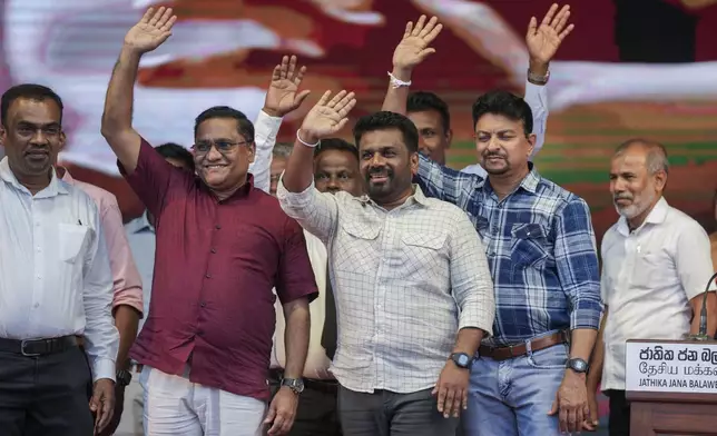 Sri Lankan President Anura Kumara Dissanayake waves with other candidates during a public rally ahead of Thursday's parliamentary election in Gampaha, Sri Lanka, Monday, Nov. 11, 2024. (AP Photo/Eranga Jayawardena)