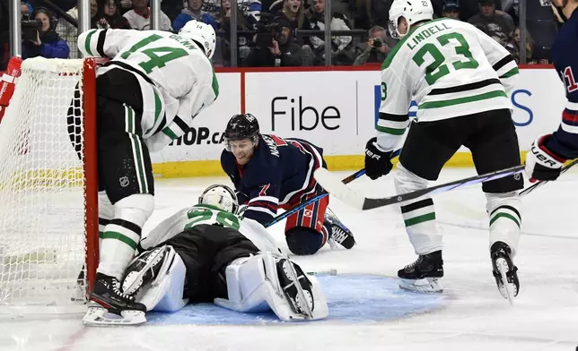 Winnipeg Jets' Vladislav Namestnikov (7) scores on goaltender Jake Oettinger (29) as Jamie Benn (14) and Esa Lindell (23) defend during the second period of an NHL hockey game in Winnipeg, Manitoba, Saturday, Nov. 9, 2024. (Fred Greenslade/The Canadian Press via AP)