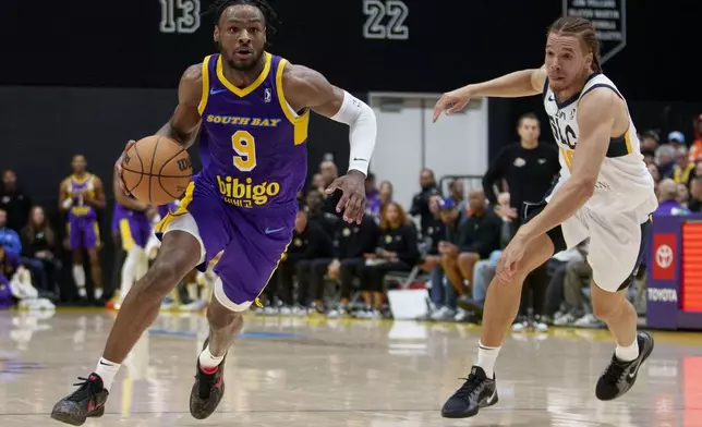 South Bay Lakers guard Bronny James (9) dribbles against Salt Lake City Stars forward Jason Preston, right, during the first half of an NBA G League basketball game Saturday, Nov. 9, 2024, in El Segundo, Calif. (AP Photo/Eric Thayer)