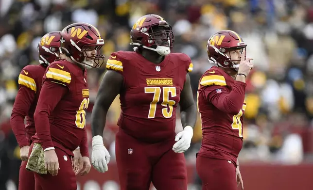 Washington Commanders place-kicker Zane Gonzalez, right, celebrates his 41-yard field goal during the second half of an NFL football game against the Pittsburgh Steelers, Sunday, Nov. 10, 2024, in Landover, Md. (AP Photo/Nick Wass)