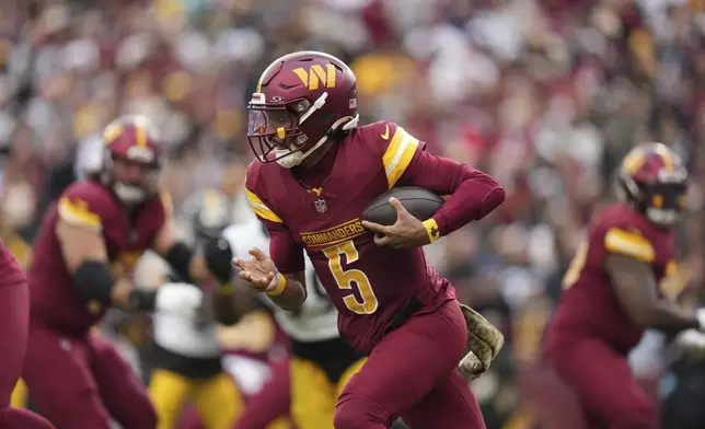 Washington Commanders quarterback Jayden Daniels scrambles during the first half of an NFL football game against the Pittsburgh Steelers, Sunday, Nov. 10, 2024, in Landover, Md. (AP Photo/Stephanie Scarbrough)