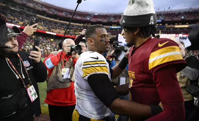 Pittsburgh Steelers quarterback Russell Wilson (3) greets Washington Commanders quarterback Jayden Daniels (5) after an NFL football game, Sunday, Nov. 10, 2024, in Landover, Md. (AP Photo/Nick Wass)