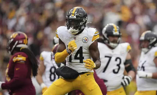 Pittsburgh Steelers wide receiver George Pickens (14) reacts after a first down during the second half of an NFL football game against the Washington Commanders, Sunday, Nov. 10, 2024, in Landover, Md. (AP Photo/Stephanie Scarbrough)