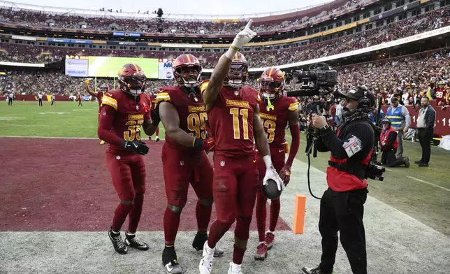 Washington Commanders safety Jeremy Chinn (11) points to the crowd after intercepting a pass intended for Pittsburgh Steelers wide receiver George Pickens during the second half of an NFL football game, Sunday, Nov. 10, 2024, in Landover, Md. (AP Photo/Nick Wass)