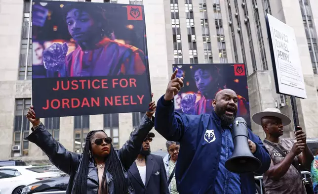 Protestors gather before Daniel Penny, the white veteran accused of choking a distressed Black subway rider to death, arrives for opening statements at the court in New York, Friday, Nov. 1, 2024.(AP Photo/Kena Betancur)