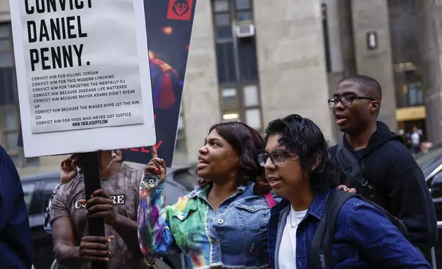 Protestors gather before Daniel Penny, the white veteran accused of choking a distressed Black subway rider to death, arrives for opening statements at the court in New York, Friday, Nov. 1, 2024.(AP Photo/Kena Betancur)