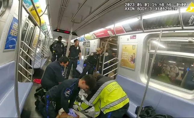 In this image from body camera video provided by New York City Police Department, emergency medical personnel in a New York City subway car attempt to revive Jordan Neely after he was placed in a chokehold by Daniel Penny on May 5, 2023. (New York City Police Department via AP)