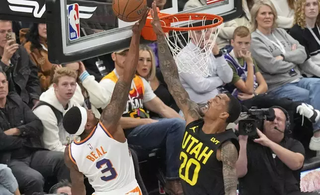 Phoenix Suns guard Bradley Beal (3) goes to the basket as Utah Jazz forward John Collins (20) defends during the first half of an Emirates NBA Cup basketball game Tuesday, Nov. 12, 2024, in Salt Lake City. (AP Photo/Rick Bowmer)