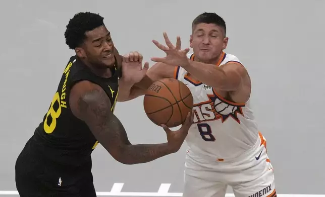 Utah Jazz forward Brice Sensabaugh, left, and Phoenix Suns guard Grayson Allen (8) battle for a loose ball during the first half of an Emirates NBA Cup basketball game Tuesday, Nov. 12, 2024, in Salt Lake City. (AP Photo/Rick Bowmer)