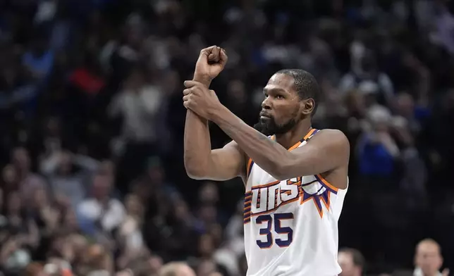 Phoenix Suns forward Kevin Durant gestures for a foul called in the final second of the second half of an NBA basketball game against the Dallas Mavericks Friday, Nov. 8, 2024, in Dallas. (AP Photo/LM Otero)