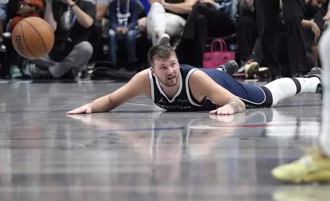 Dallas Mavericks guard Luka Doncic looks for the foul to be called after he fell during the second half of an NBA basketball game against the Phoenix Suns Friday, Nov. 8, 2024, in Dallas. (AP Photo/LM Otero)