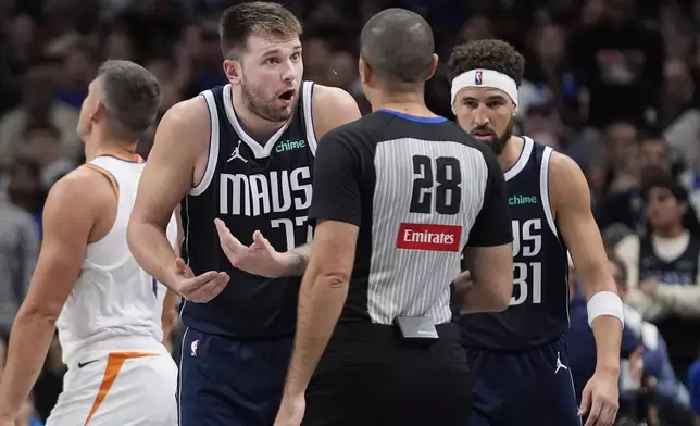 Dallas Mavericks guard Luka Doncic (77) questions a call to referee Mousa Dagher (28) as guard Klay Thompson (31) looks on during the second half of an NBA basketball game against the Phoenix Suns Friday, Nov. 8, 2024, in Dallas. (AP Photo/LM Otero)