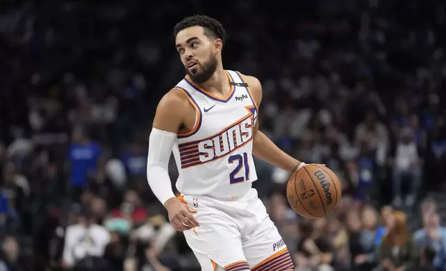 Phoenix Suns guard Tyus Jones (21) moves the ball during the first half of an NBA basketball game against the Dallas Mavericks Friday, Nov. 8, 2024, in Dallas. (AP Photo/LM Otero)