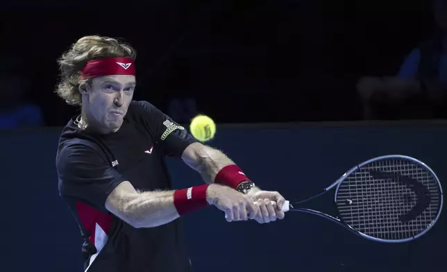 Russia's Andrey Rublev returns a ball to Ben Shelton of the U.S. during their quarter final match at the Swiss Indoors tennis tournament at the St. Jakobshalle in Basel, Switzerland, Friday, Oct. 25, 2024. (Georgios Kefalas/Keystone via AP)