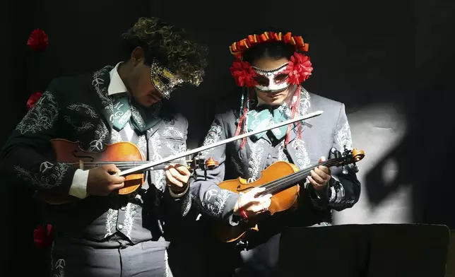 Members of the Pharr San Juan Alamo Memorial Early College Generaciones mariachi tune up during the 6th Annual Dia De Los Muertos Celebration at PSJA Memorial Early College High School, Friday Nov. 1,2024, in Alamo, Texas. (Delcia Lopez/The Monitor via AP)