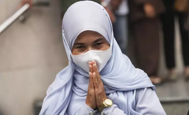 Wanna Suansan, who had been charged with involvement in a 2015 bombing, leaves the Bangkok South Criminal Court in Bangkok, Thailand, Thursday, Nov. 7, 2024. (AP Photo/Sakchai Lalit)