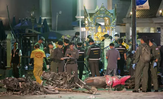 FILE - Police investigate the scene at the Erawan Shrine after an explosion in Bangkok on Aug. 17, 2015. (AP Photo/Mark Baker, File)