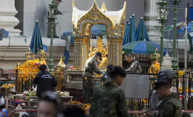 FILE - Police investigate the scene around the Erawan Shrine the morning after an explosion in Bangkok,Thailand, Tuesday, Aug. 18, 2015. (AP Photo/Mark Baker, File)