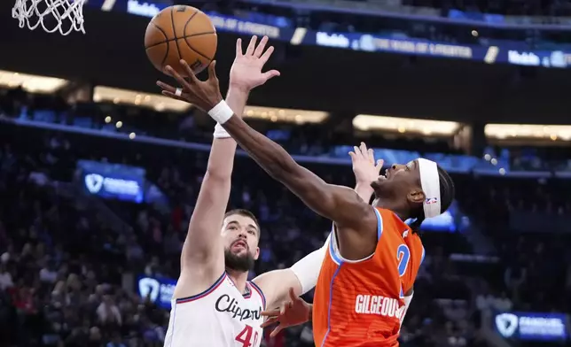 Oklahoma City Thunder guard Shai Gilgeous-Alexander, right, shoots as Los Angeles Clippers center Ivica Zubac defends during the first half of an NBA basketball game, Saturday, Nov. 2, 2024, in Inglewood, Calif. (AP Photo/Mark J. Terrill)