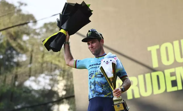 Mark Cavendish of Astana Qazaqstan poses on the podium during podium ceremony of the Tour de France Prudential Singapore Criterium, Sunday, Nov. 10, 2024. (AP Photo/Danial Hakim)