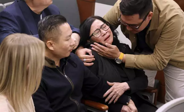 Bong Le, mother of a stabbing victim Khuong Nguyen, reacts to the guilty verdict in defendant Julius Trotter's murder trial, Tuesday, Oct. 29, 2024, at the Regional Justice Center in Las Vegas. Comforting Le is Hung Quang Nguyen, husband of a stabbing victim Sang Nghia, second left, and Tuan Trinh. At rear is interpreter Jimmy Tong Nguyen. ( (K.M. Cannon/Las Vegas Review-Journal via AP)