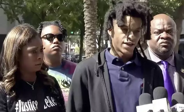 In this image taken from from video, Le’Keian Woods, who filed a federal lawsuit against three Jacksonville sheriff's officers who severely beat him last year after he ran from a traffic stop, alleging they used excessive force that resulted in permanent injuries to his head, an eye and a kidney, speaks during a news conference, Thursday, Oct. 31, 2024, in Jacksonville, Fla. (WJXT via AP)