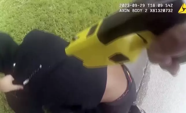 In this image taken from video from police a body worn camera, a Jacksonville sheriff's officer holds down Le’Keian Woods while pointing a stun gun at him following a traffic stop on Sept. 29, 2023, in Jacksonville, Fla. (WJXT via AP)