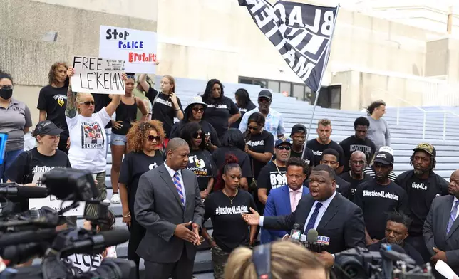 FILE - Legal team member Harry M. Daniels speaks during a media press conference while, from left, legal team member Roderick Taylor, in suit, Natassia Woods, the mother of Le'Keian Woods, and legal team member Marwan Porter listen, Oct. 3, 2023, on the steps of the Jacksonville Sheriff's Office in Jacksonville, Fla. (Corey Perrine/The Florida Times-Union via AP, File)