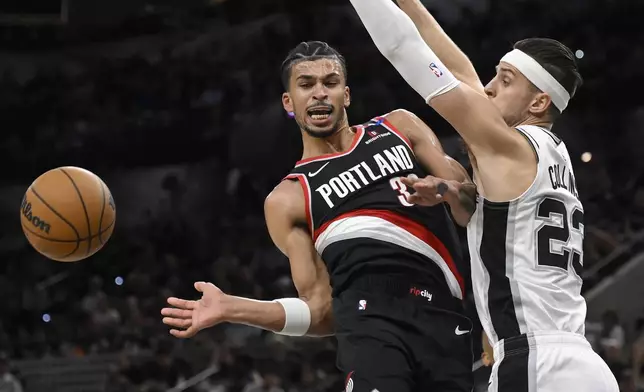 Portland Trail Blazers' Toumani Camara, left, collides with San Antonio Spurs' Zach Collins during the first half of an NBA basketball game, Thursday, Nov. 7, 2024, in San Antonio, Texas. (AP Photo/Darren Abate)