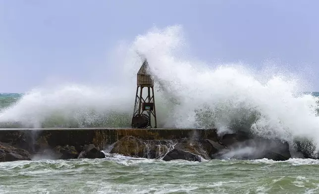 Waves crash against the jetty at the Bal Harbour Lighthouse on Tuesday, Nov. 5, 2024, in Bal Harbour, Fla. (David Santiago/Miami Herald via AP)