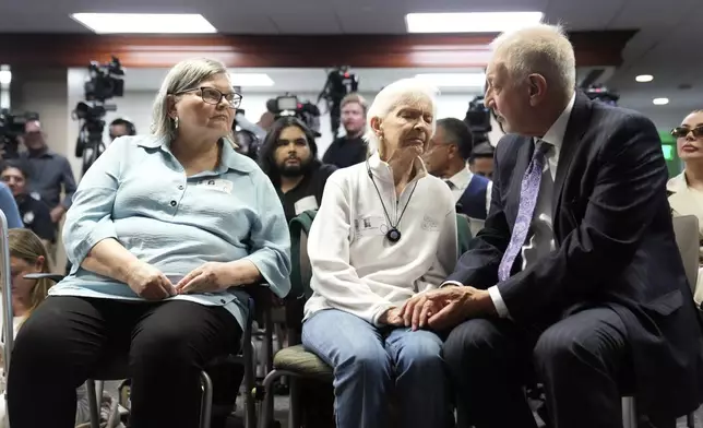 FILE - Kitty Menendez's sister, Joan Andersen VanderMolen, center, is greeted by Defense Attorney Mark Geragos as Diane Hernandez, niece of Kitty Menendez, left, looks on, prior to a news conference being held by Los Angeles County District Attorney George Gascon at the Hall of Justice, Oct. 24, 2024, in Los Angeles. (AP Photo/Eric Thayer, File)