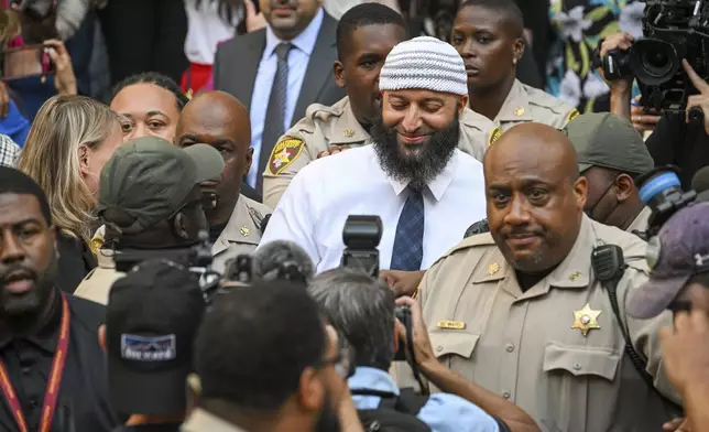 FILE - Adnan Syed, center, the man whose legal saga spawned the hit podcast "Serial," exits the Cummings Courthouse after a Baltimore judge overturned his conviction for the 1999 murder of high school student Hae Min Lee on Sept, 19, 2022, in Baltimore. (Jerry Jackson/The Baltimore Sun via AP, File)