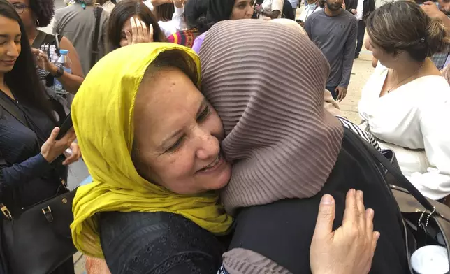 FILE - Shamim Syed, Adnan Syed's mother, left, celebrates with others outside the Cummings Courthouse, Sept. 19, 2022, in Baltimore after a judge ordered the release of her son, Adnan Syed, overturning his conviction for a 1999 murder that was chronicled in the hit podcast "Serial." (AP Photo/Brian Witte, File)