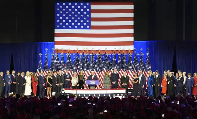 Donald Trump speaks at an election night watch party, joined by a crew of longtime friends, aides and new allies. (AP Photo/Lynne Sladky)