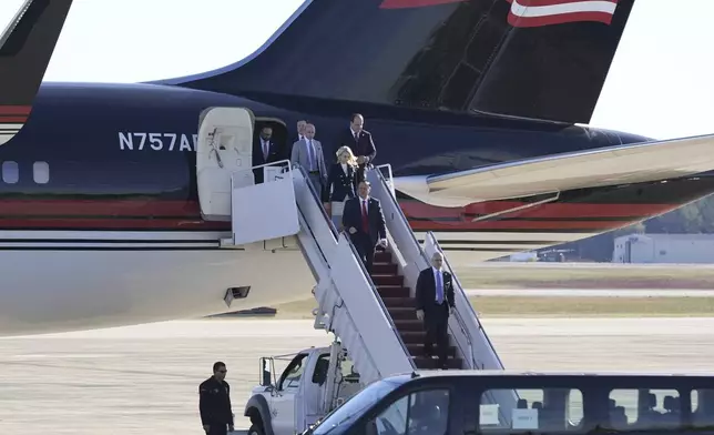 Elon Musk and others, walk off President-elect Donald Trump's airplane, as he arrives at Joint Base Andrews, Md., Wednesday, Nov. 13, 2024. (AP Photo/Alex Brandon)